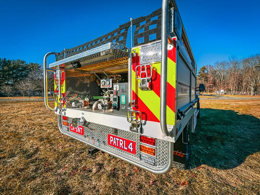 Rear-right three-quarter view with open pump panel and chevrons.