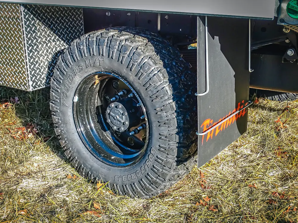 Rear wheel and mudflap close-up from right side.