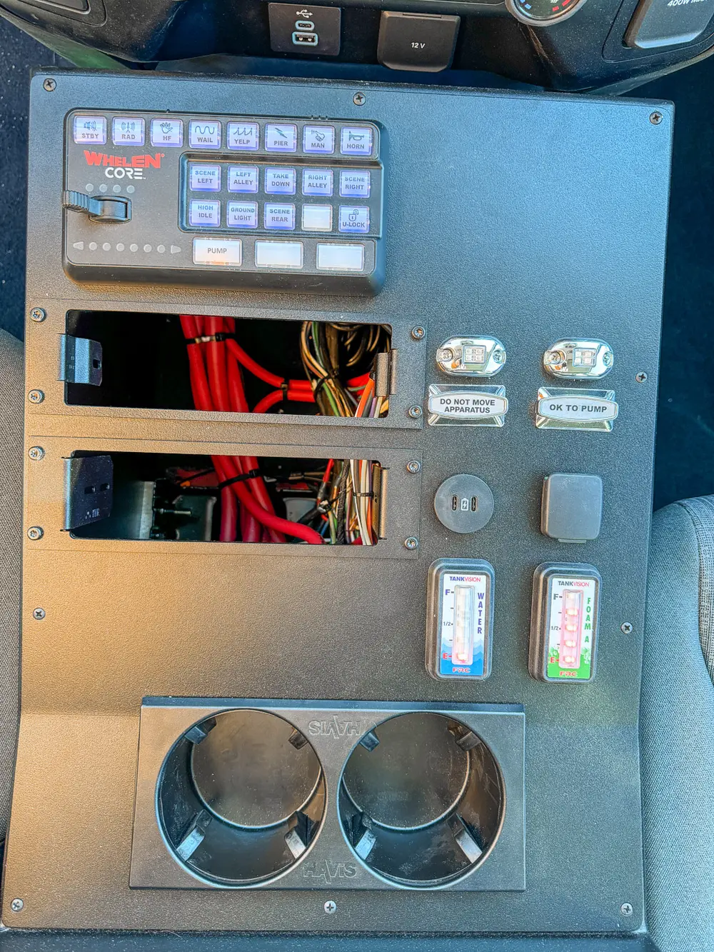 Center control panel close-up with wiring bay and switches.