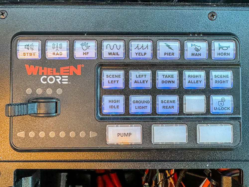 Whelen control keypad close-up on the center console.