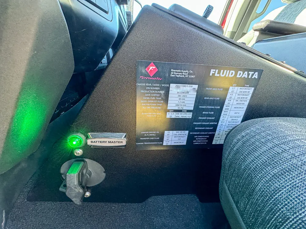 Passenger-side interior panel with fluid data label and key switch.