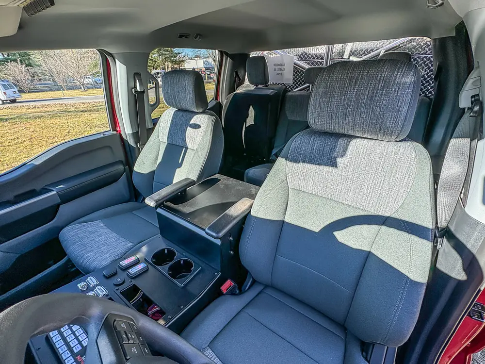 Wide interior view across front and rear seats from passenger side.