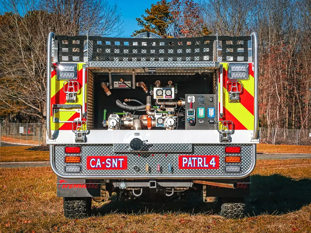 Straight rear view showing pump controls and rear hose storage.
