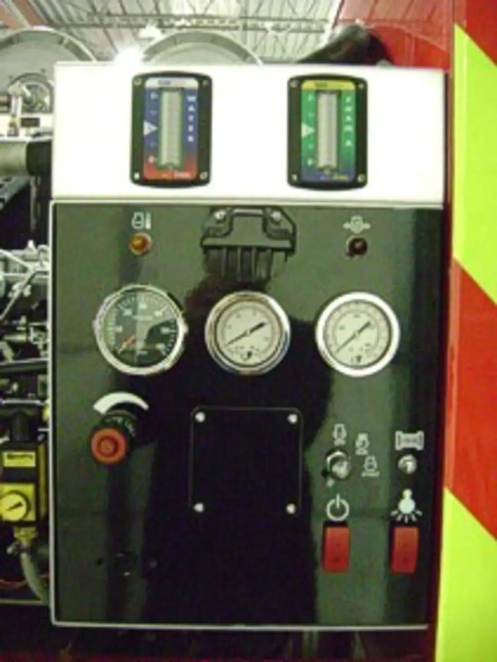 Exterior view of small fire truck showing cab, body compartments, and wheel/tire area.