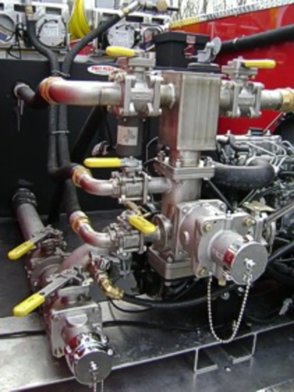 Exterior view of small fire truck showing cab, body compartments, and wheel/tire area.