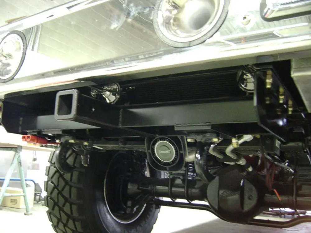 Exterior view of small fire truck showing cab, body compartments, and wheel/tire area.