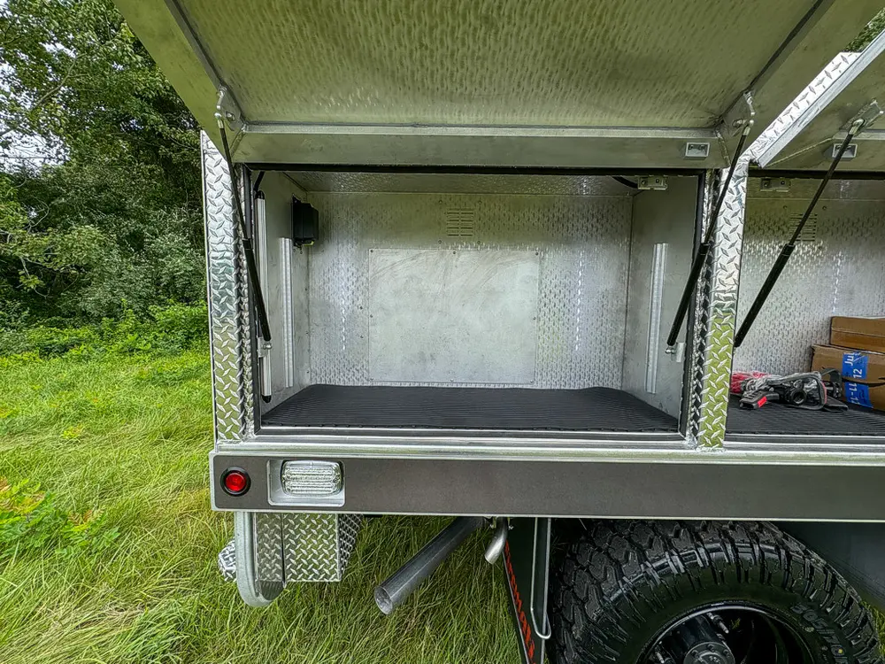 Open side compartment with shelf and empty storage interior.