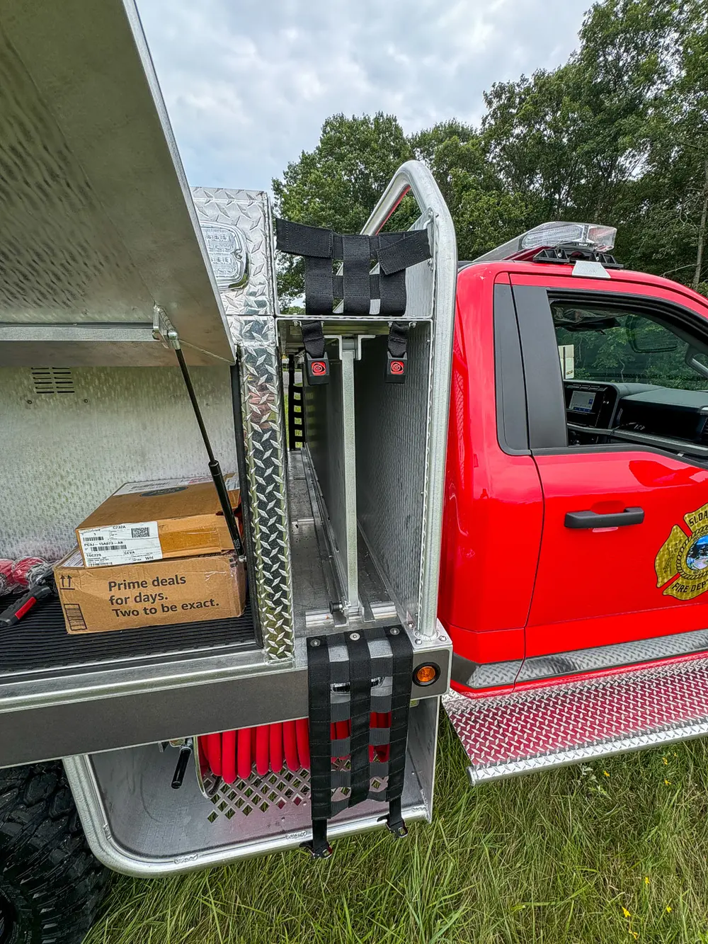 Front-side compartment close-up with box and intake opening behind cab.