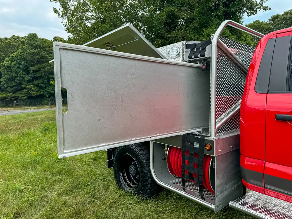 Long side compartment door open outward along utility body.