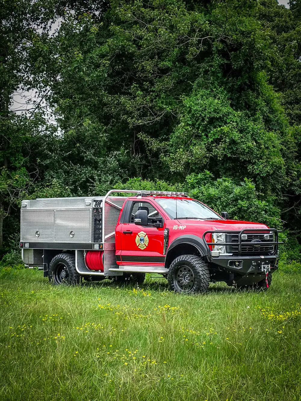 Left-side profile showing cab and long aluminum utility body.
