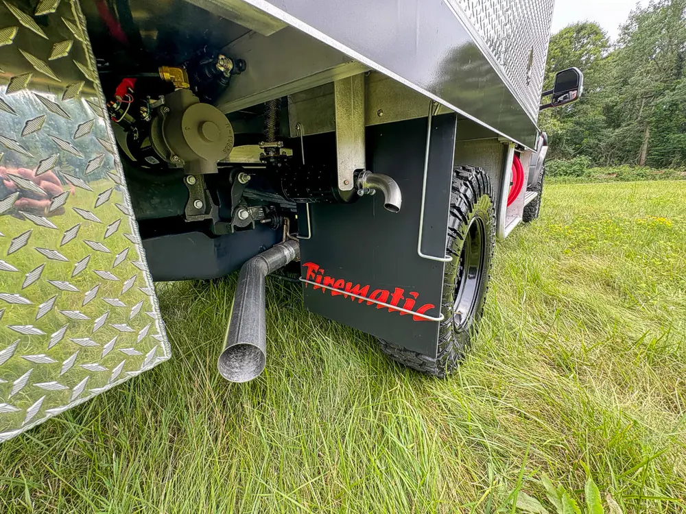 Underside rear side close-up with exhaust outlet and hitch hardware.