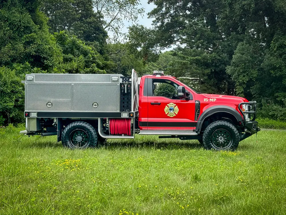 Full right-side profile of truck parked on grass.