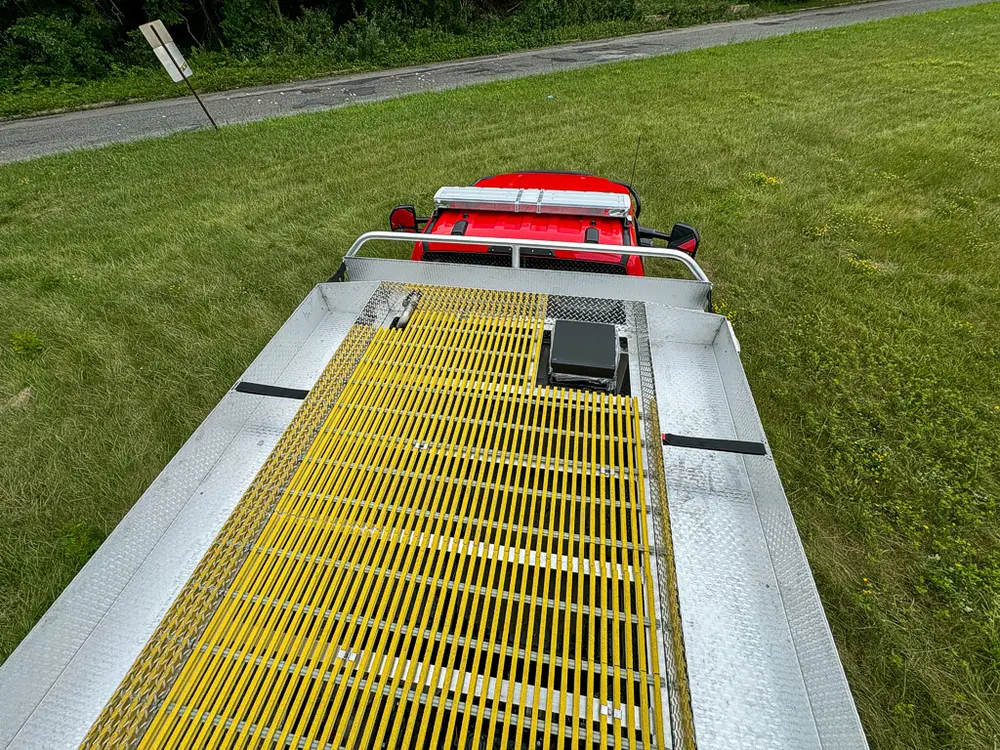 Top deck view along yellow grated walkway toward cab.