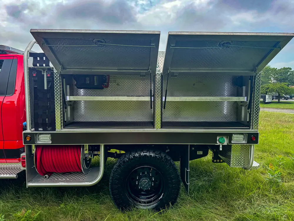 Right-side profile with upper compartment doors raised open.