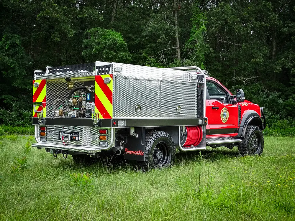 Rear-right three-quarter view with rear pump area and side compartments.