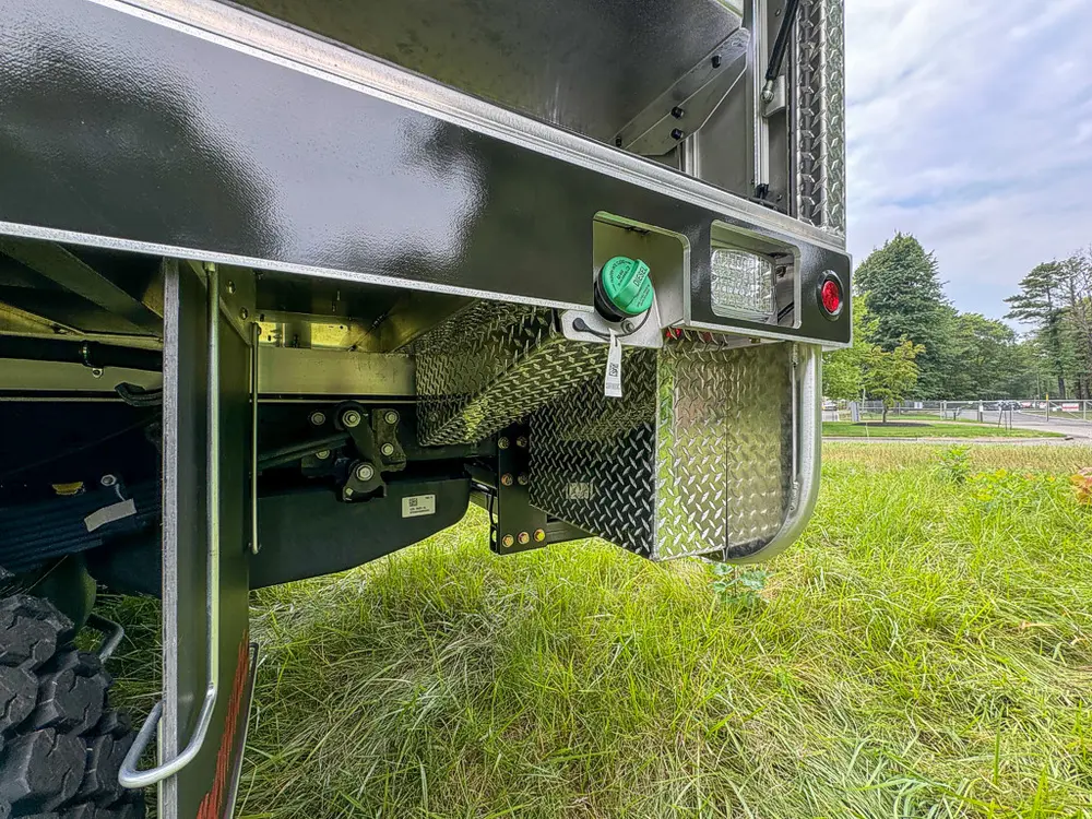 Lower side body close-up with outlet panel and marker light.