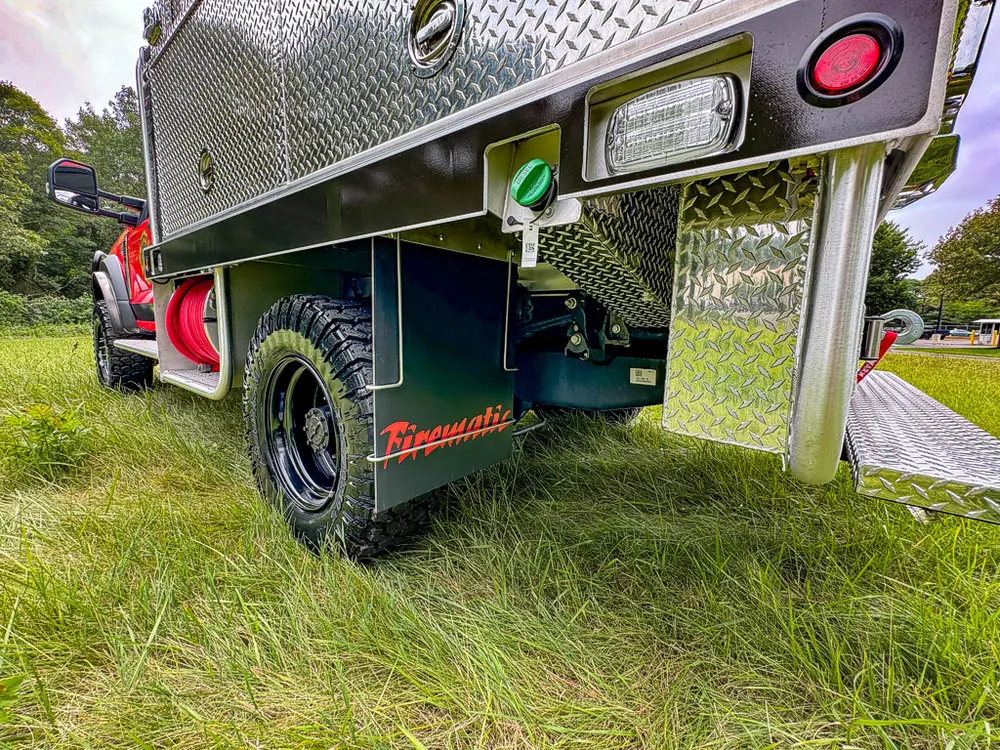 Right-side rear underbody view with wheel and mudflap visible.