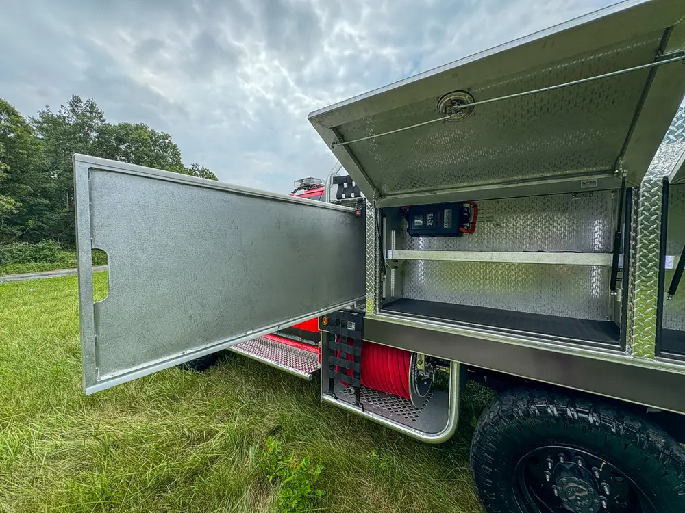 Long side compartment door open outward with interior shelves visible.