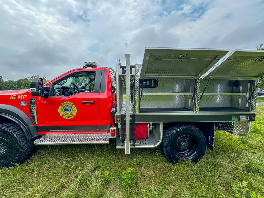 Right-side profile with multiple compartment doors raised open.