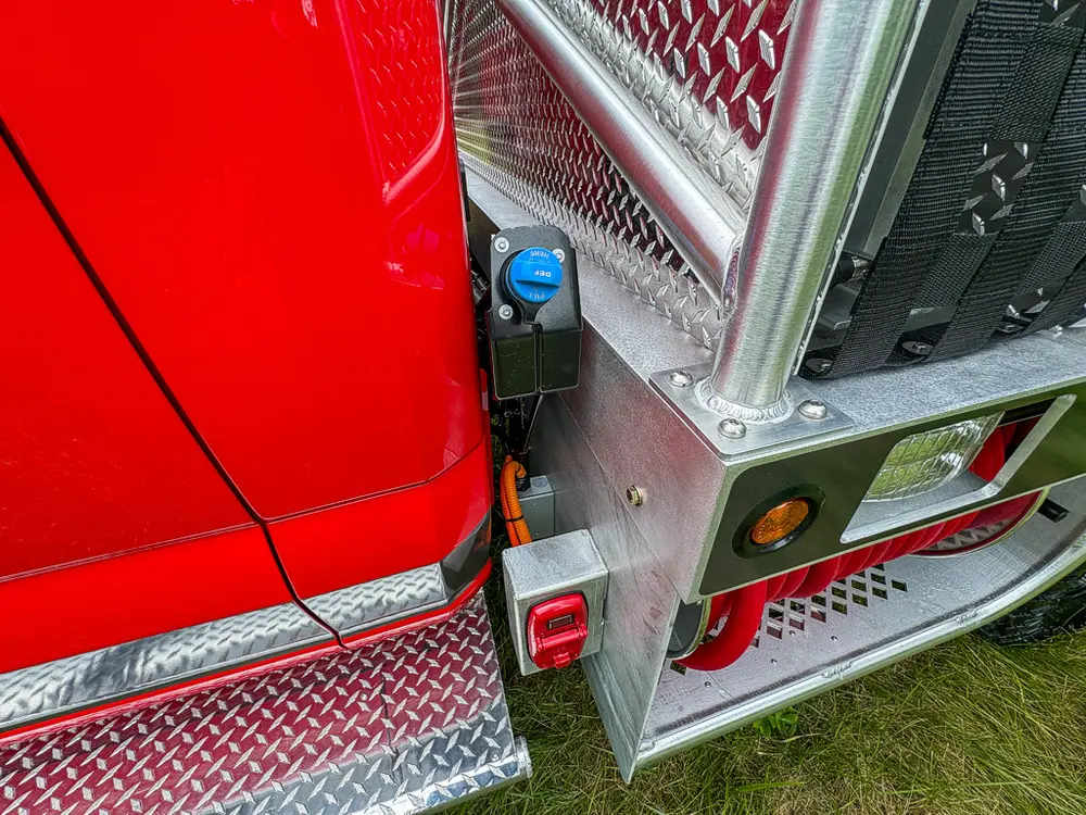 Cab-to-body junction close-up with blue fitting and diamond-plate trim.