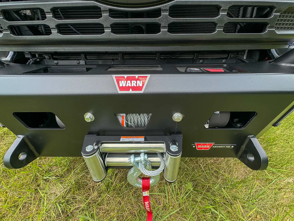 Front bumper close-up with winch fairlead and tow points.