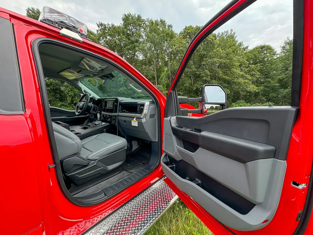 Open driver door view showing front seat and interior door panel.