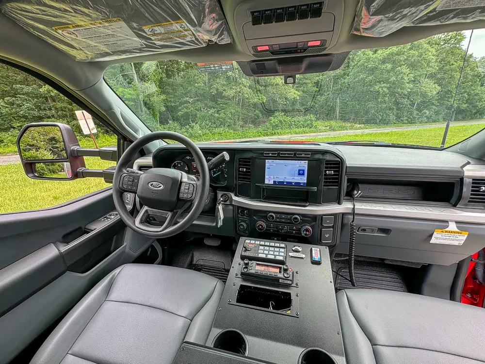 Wide dashboard and steering area view from open driver door.