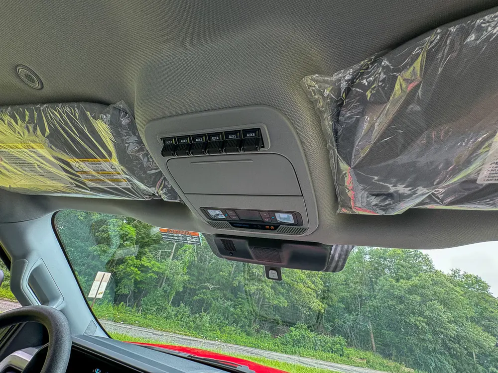 Upper interior roof console close-up with lighting and controls.