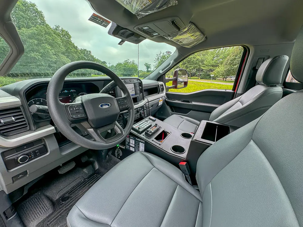 Wide front interior shot from passenger side with dashboard and seats.