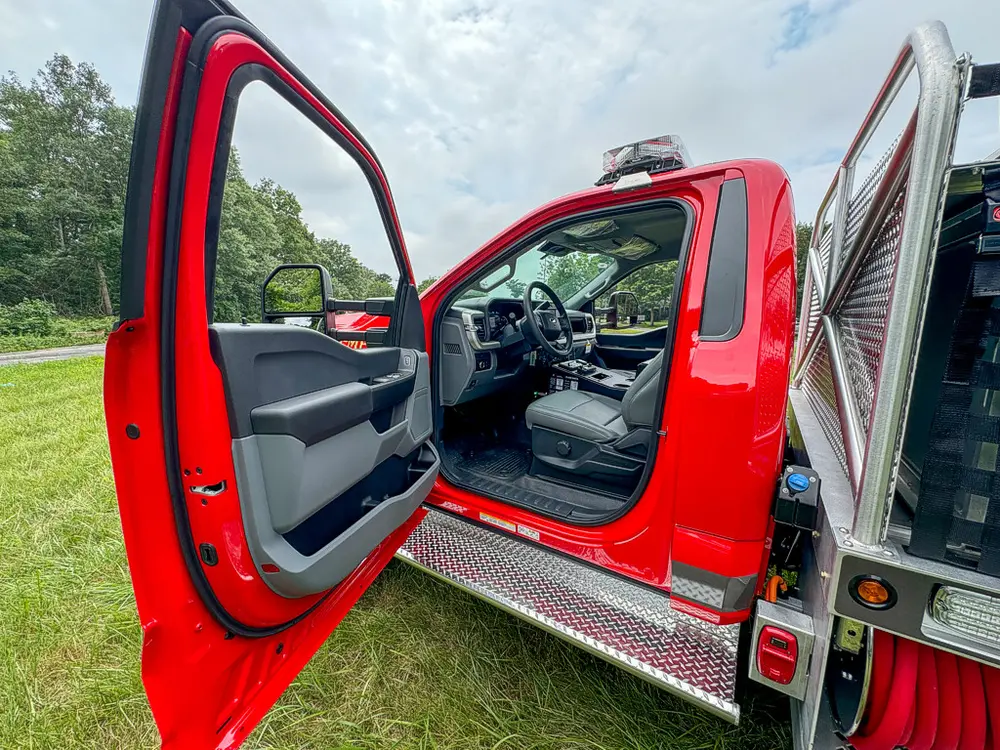 Open driver-side exterior view with door and side step visible.