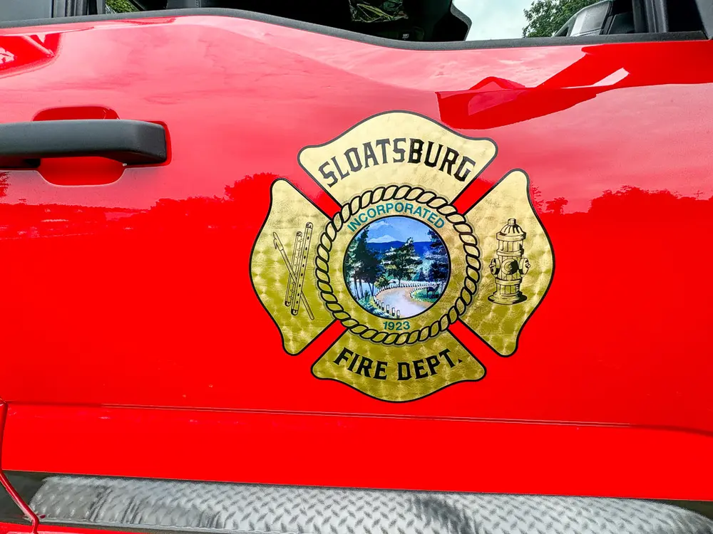 Door emblem close-up with Sloatsburg Fire Department crest.