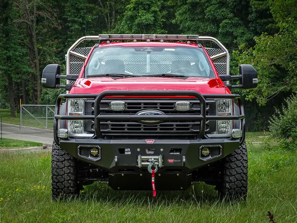 Head-on front view with grille, bumper, and winch fairlead.