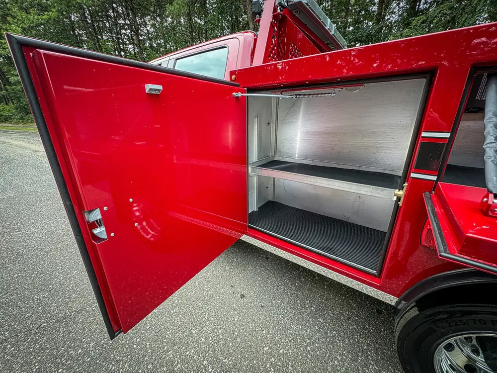 Open side compartment door with shelf and clean interior.