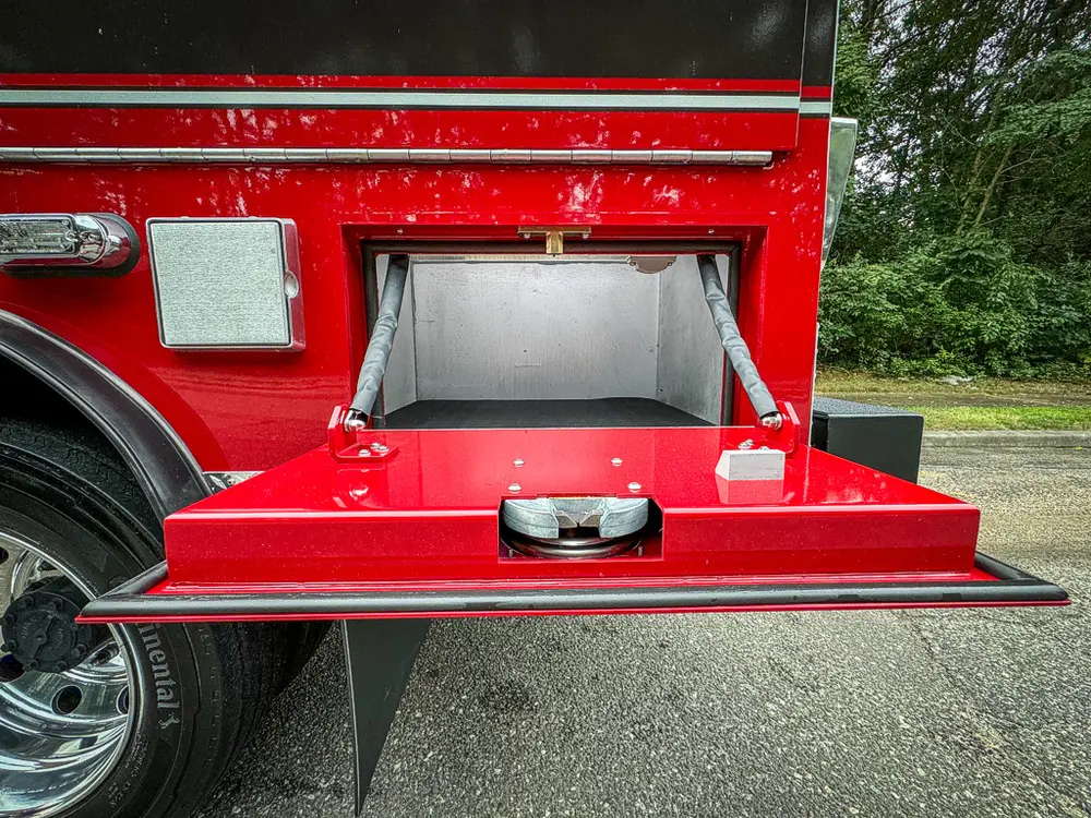 Lower side fold-down compartment open with intake fitting visible.