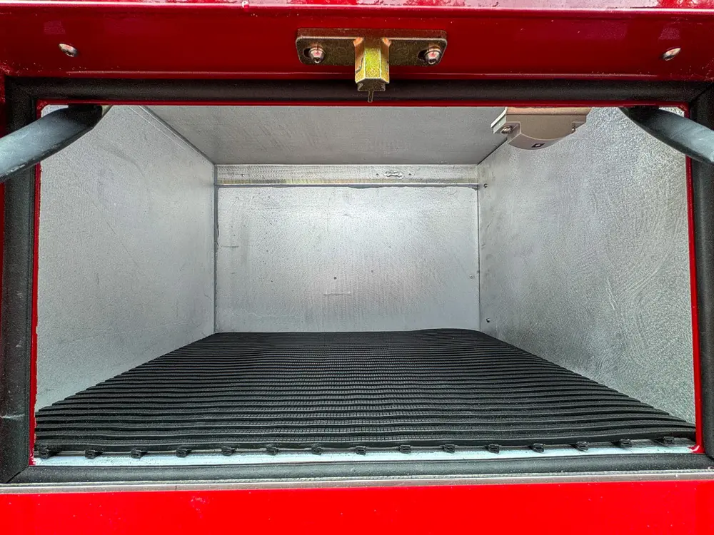 Lower side compartment interior close-up with empty floor space.