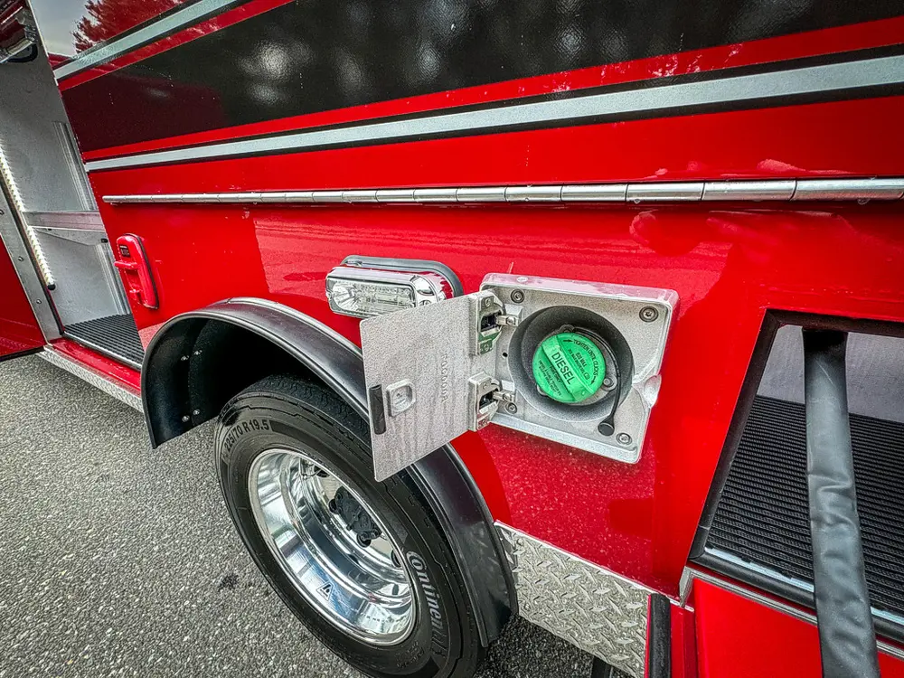 Lower side panel with open intake-port door and connection fitting.