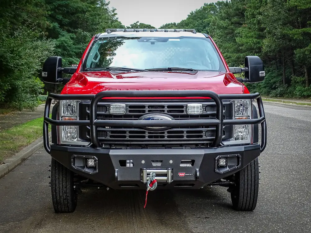 Head-on front view showing grille, brush guard, and bumper winch.