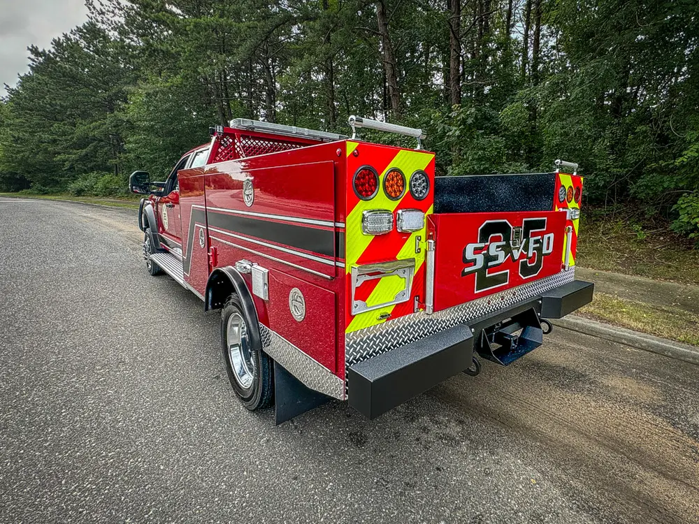 Rear-left three-quarter view with tailgate and rear sidewalls visible.