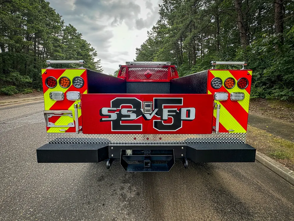 Straight rear view showing chevron rear panel and tailgate.