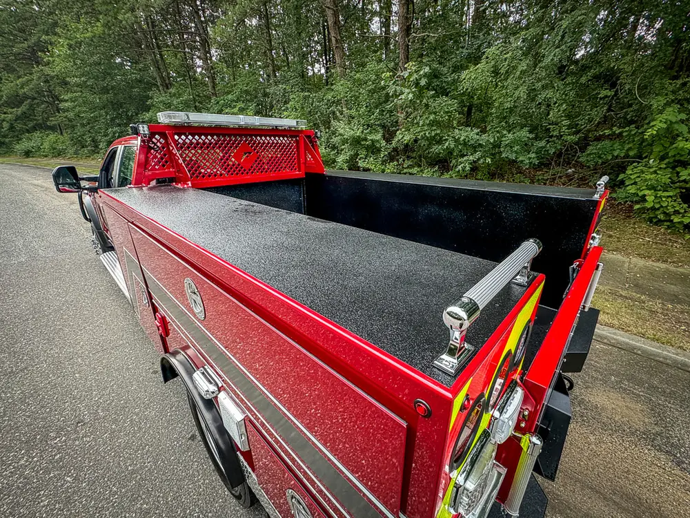 Pickup-bed interior view from rear-left corner with sidewalls raised.