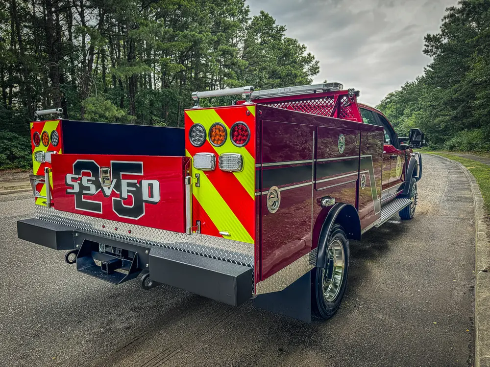 Rear-right three-quarter view with open cargo bed and side panels.
