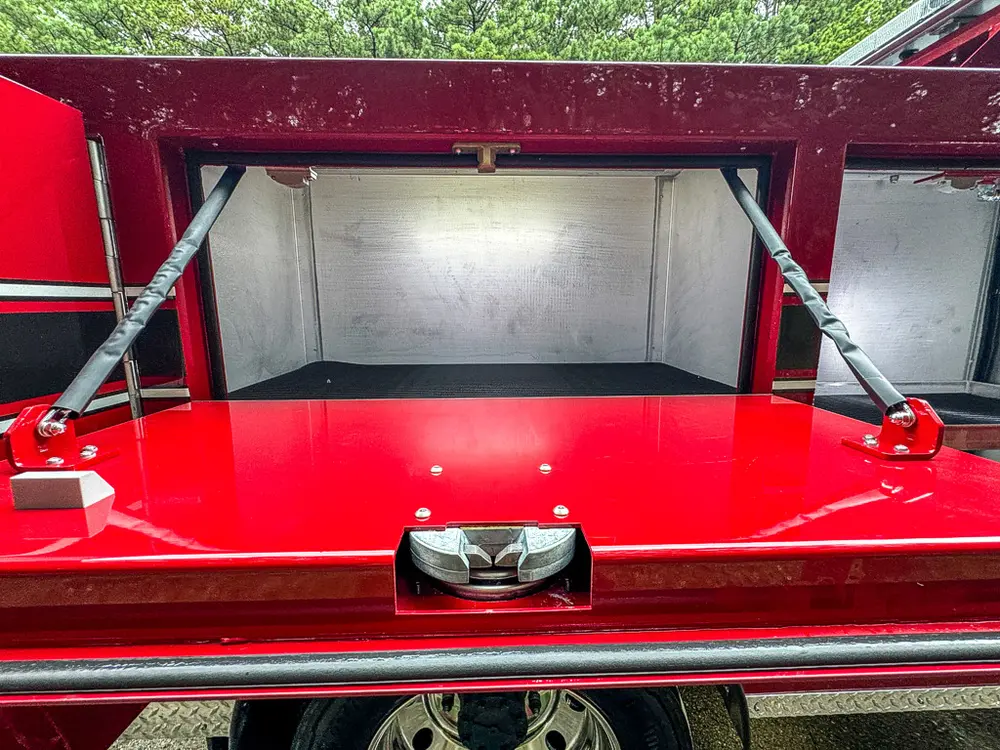 Long top-side compartment open with empty red-lined storage bay.
