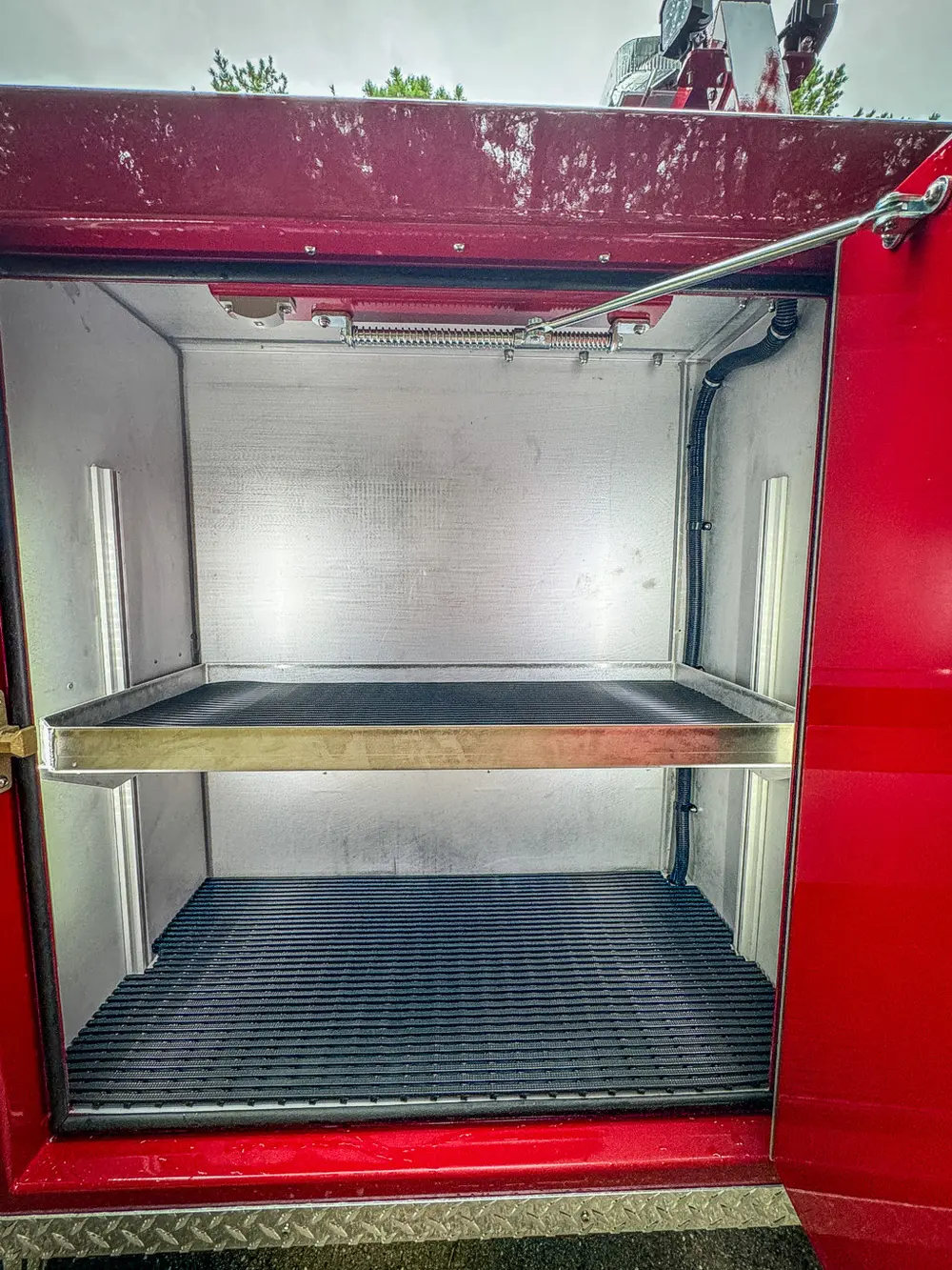 Open side compartment with shelf and blank rear wall.