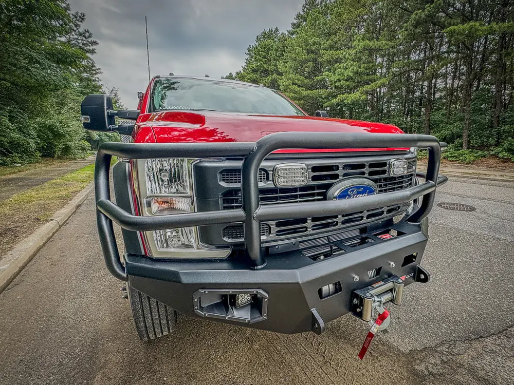 Head-on front view close-up with brush guard and bumper winch.