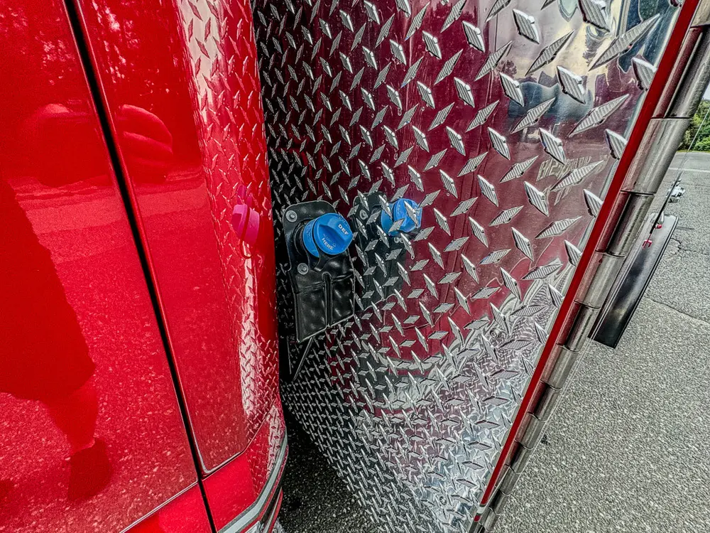 Diamond-plate panel close-up at rear cab-side body transition.