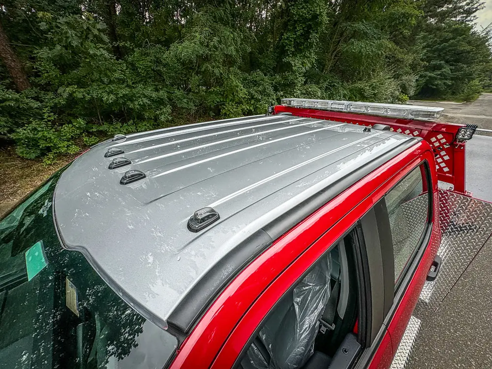 Cab roof close-up showing silver roof panel and marker lights.