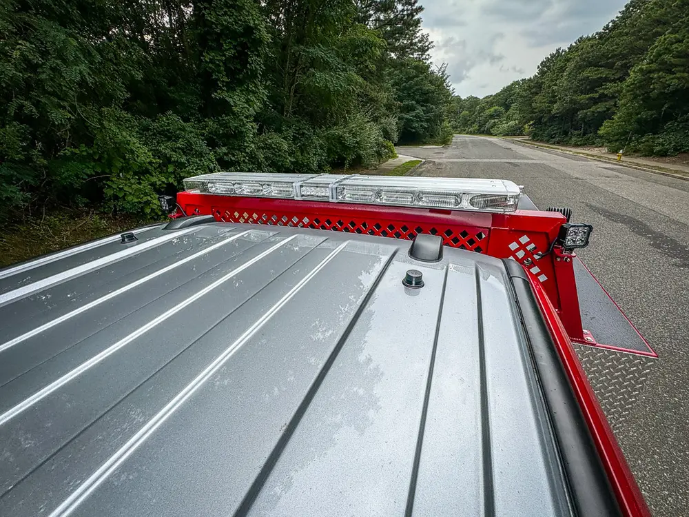 Cab roofline and rear rack lightbar close-up from above.