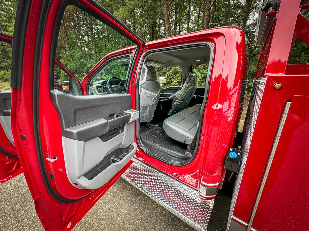 Open rear cab door view showing rear seat and door panel.