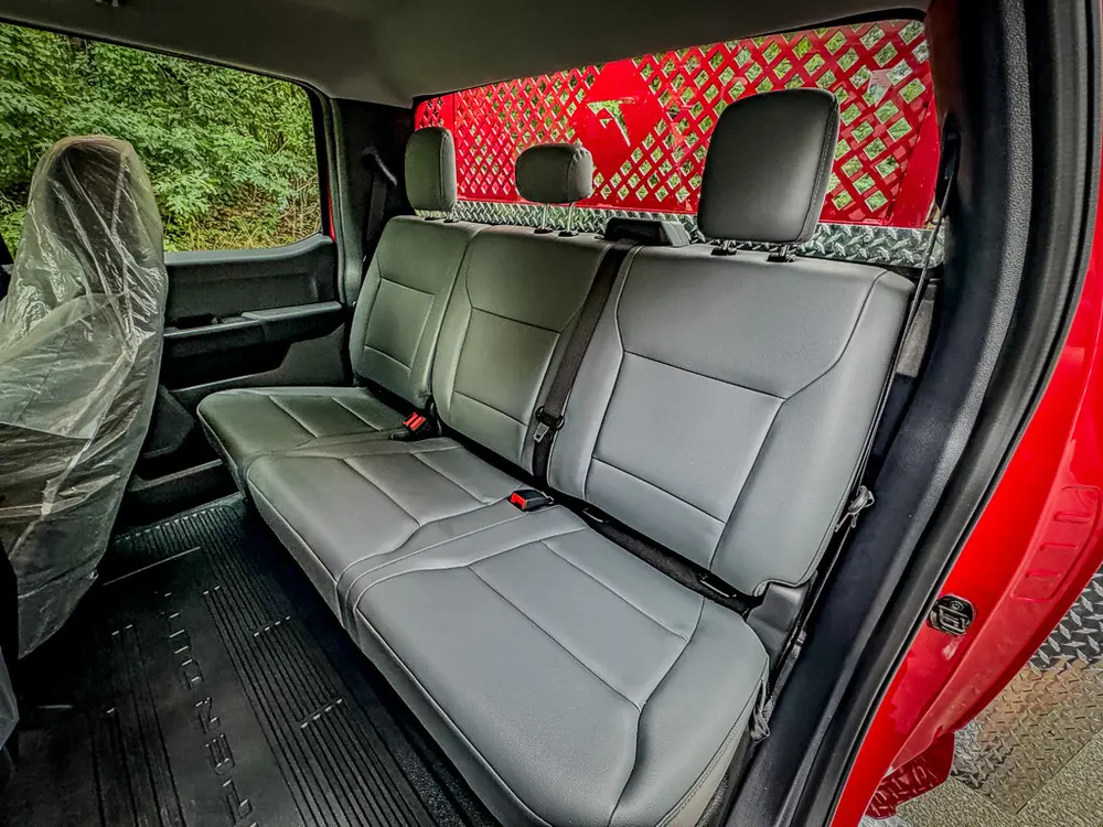 Rear bench seat view with center armrest and floor area.