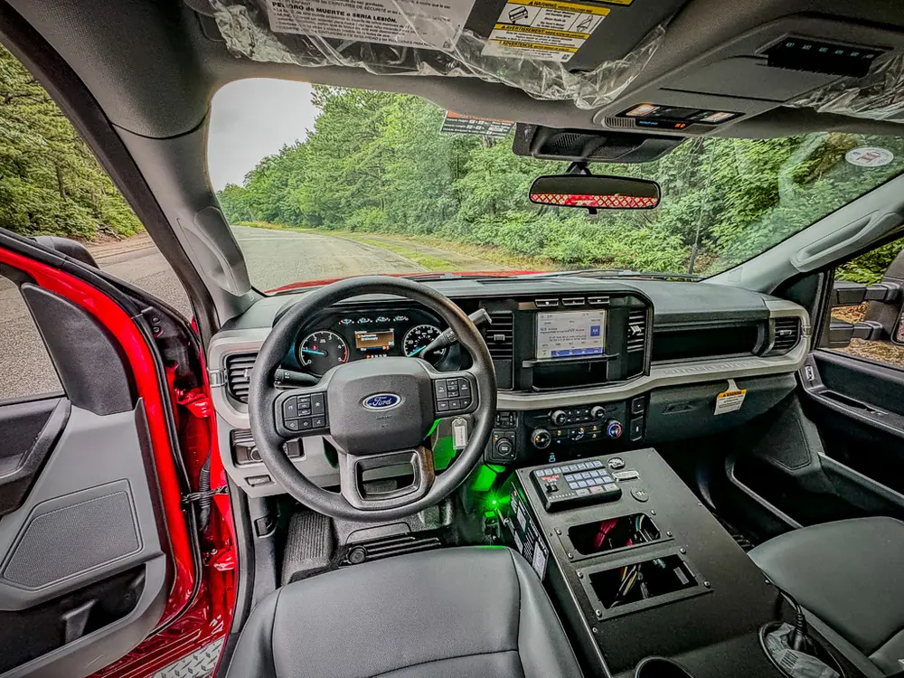 Driver-side interior view with steering wheel and center controls.